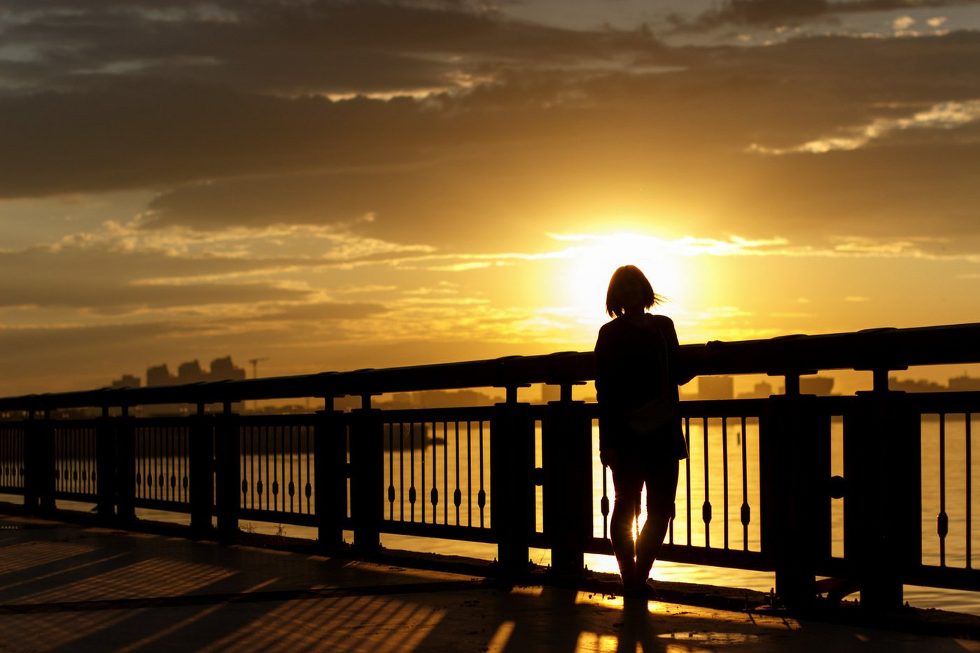 Девушка на мосту на закате